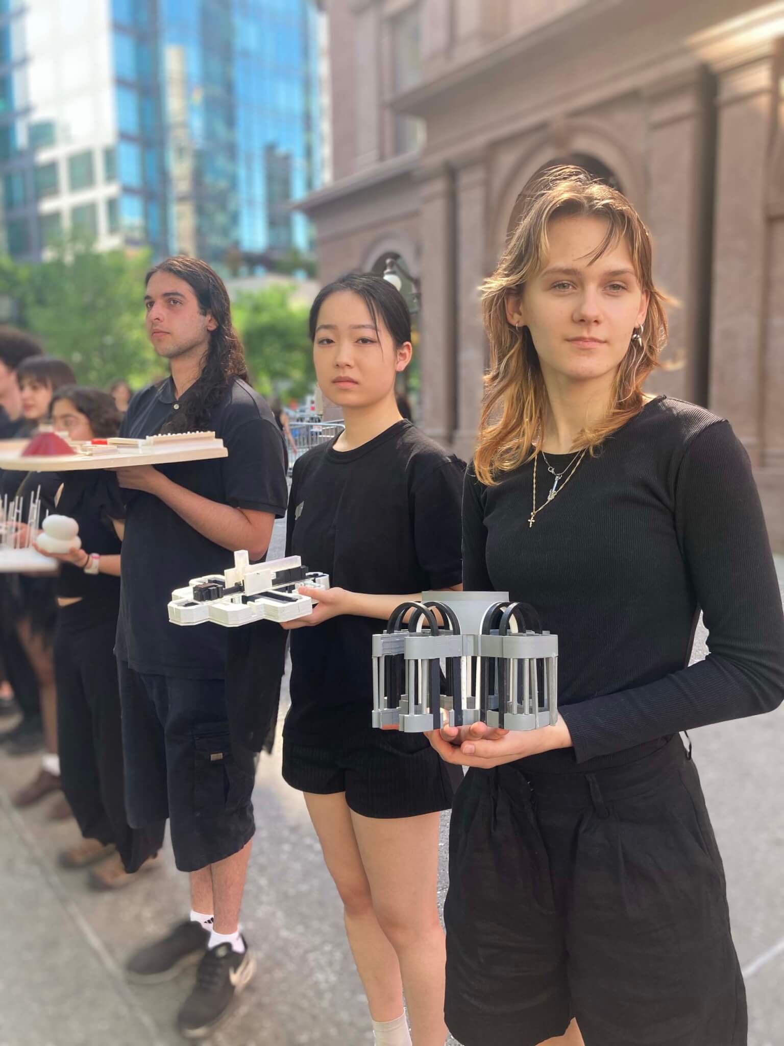 students holding models